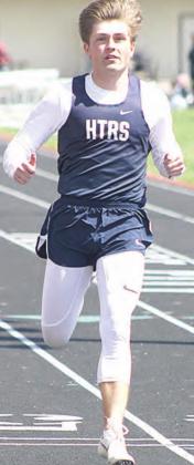 HTRS’ Aly Howe (above left) carries the baton in the girls’ 3200 M. Relay while HTRS’ Jayden McNealy (right) makes a strong finish in the boys’ 100 M. Dash prelims at the Lewiston Invitational on Tuesday. Paula Jasa/Republican