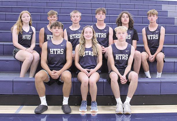Members of the 2026 HTRS Cross Country team are (L-R front row) Seniors: Kameon Dettmann, Grayson Sherman and Axton Wamsley Second Row: Shawnna Richey, Preston Mezger, Ewan Guenther, Ty Dunekacke, Michael Wanek-Flores and Tate Dunekacke. Head Coach: Madi Bredemeier. Assistant Coach: Michelle Glathar