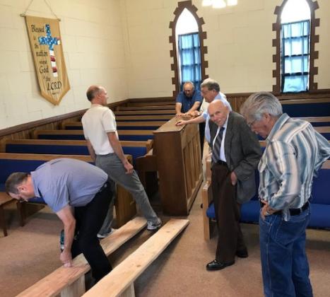 You can see the congregation relocating the piano to prepare the church for the meetings. you can see the custom made ramps they used to get the piano up the steps. It was facsinating to watch the farmers knowhow and muscle to get-r-done.