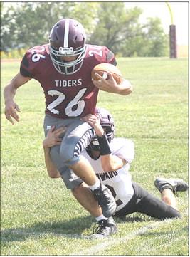 LHS’ Alex Seeman (#26) drags a St. Edward tackler down the sidelines in Friday’s home opener. Seeman rushed 13 times for 129 yards with 2 TD’s. Paula Jasa/Republican