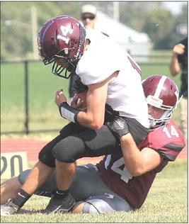 LHS’ Caleb Rule (#14, right) brings down a St. Edward ball-carrier in Friday’s 81-41 victory. Paula Jasa/Republican