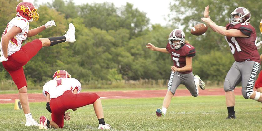 LHS’ Brody Wright (#61, right) blocks a Red Cloud PAT attempt early in the game as teammate Cashton Steinacher (#7, right) also rushes in. Wright blocked two PAT kicks in the game which LHS lost, 26-72. Paula Jasa/Republican