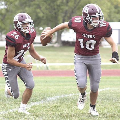 LHS’ Everett Bohling (#10, right) reaches back to hand off to teammate Alex Seeman (#26, left) in the game against Red Cloud last week. Paula Jasa/Republican