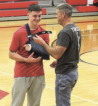 Jett Farwell (left) was recognized for breaking his dad, Mike Farwell's previous 100 m record