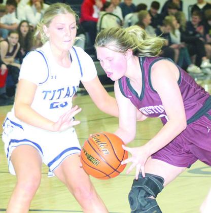 LHS’ Ayden Hunzeker (right) drives against HTRS’ Jaylie McNealy (#23, left) in Tuesday night’s game. Paula Jasa/Republican