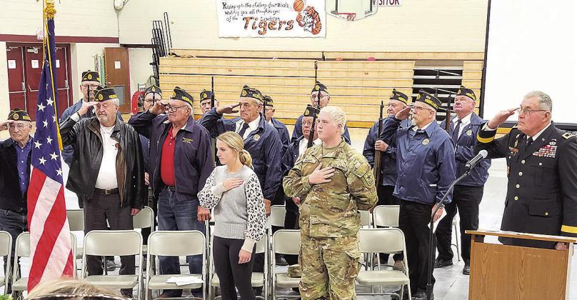 Veterans lead the Pledge of Allegiance during the Veteran's Day program at Lewiston School