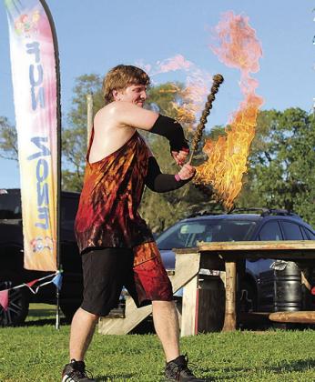 A fire dancer performs in the Fun Zone Photo by Reagan Connelly