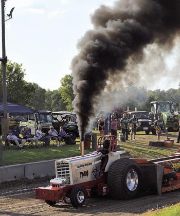 Black smoke plumes out of a tractor Photo by Denielle Gyhra