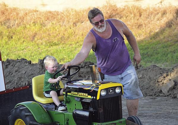 Russ Smith and his grandson in the garden tractor pull Photo by Denielle Gyhra