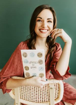 Reyana Tegtmeier with her book of poetry.