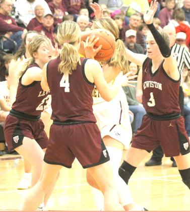 LHS’ defense including DeLayne Currie, Emma DeKoning (#4) and Katelyn Sanders (#3, right) defends the lane on Friday night. Paula Jasa/Republican