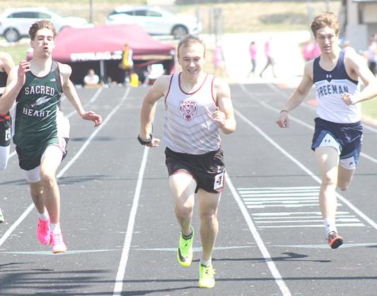Pictured at the Lewiston Invite on Tuesday included: from left, HTRS’ Brandt Leech in the Pole Vault; above, LHS’ Carleigh Weyers in the 100 M. Hurdles; right, HTRS’ Jaylie McNealy in the 3200 M. Relay; below center, LHS’ Kaden Wagner in the 100 M. Dash prelims. photos by Paula Jasa/Republican