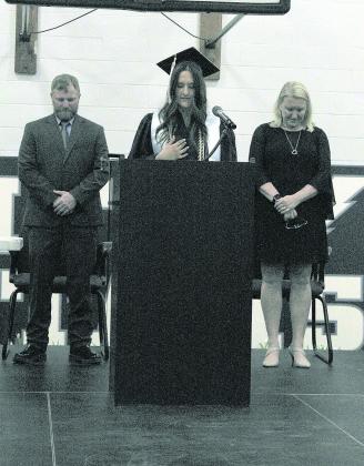 Top left: HTRS graduates from left to right: Jorja Dejonge, Shayfer Cumro, Zachary Burns, Elizabeth Bstandig, Madison Bredemeier, Kirk Bass Top right: Flanked by Kyle Hilgenfeld (left) and Kim Caniglia (right), Shayfer Cumro (center) delivers the invocation. Bottom left: Emmet Glathar gives a tulip to a family member during the Presentation to Families Bottom right: Jon Koch (left) and Lillian Bowen (right) deliver the class address.