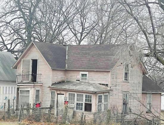 Ray Kappel/Republican The house once lived in by Donnie Graham was torn down Friday by Gyhra’s Construction. Derek Gyhra ran the Cat 324E. It took over two hours to get it into a pile. The late Donnie’s brother Jerry watched the house come down.