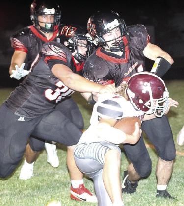 LHS’ Cashton Steinacher (#7, right) gets brought down short of the goal line by P.C.’s Dylan Layne (#30, left) and Jett Farwell (right) on a huge 4th down play. Paula Jasa/Republican