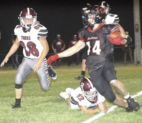 P.C.’s Jett Farwell (#14, right) eludes several Lewiston tacklers including Ashton Sanders (#12, below) and Zander Wagner (#88, left) on his way for a touchdown. Farwell scored 5 touchdowns in the game and had 244 yards of rushing. Paula Jasa/Republican