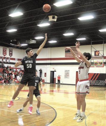 HTRS Titan Cole Hunzeker jumps to block Pawnee City Indian Jordan Wernimont’s shot