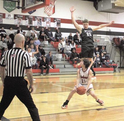 Pawnee City Indian Braydon Frakes prepares to make a shot as HTRS Titan Emmett Glathar jumps to block it