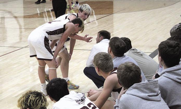Lewiston Tigers Grady Weyers and Cashton Steinacher consult with Coach Kyle Asche courtside