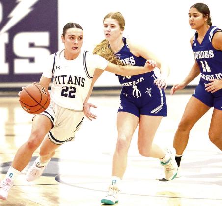 HTRS’ Lillian Bowen (#22, left) drives past two NCL Lady Knight defenders on her way down the floor. Bowen scored 13 points for HTRS in their close 49-54 loss. Photo courtesy of Lorrie Novak
