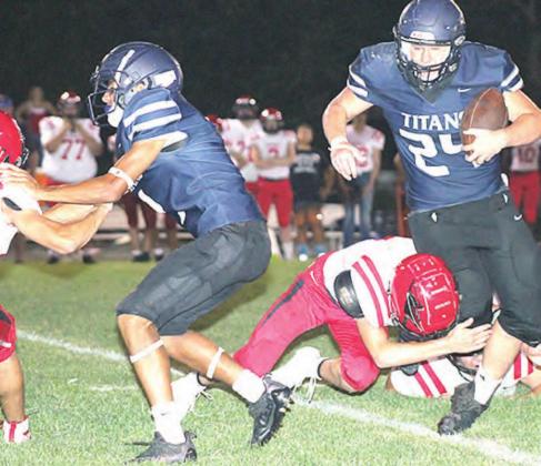 HTRS’ Aiden Worthey (#24, right) tries to run over a tackler as teammate JJ McQueen (left) blocks out front. Paula Jasa/Republican
