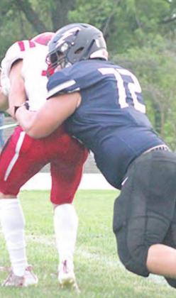 HTRS’ Ryken Davis (#72) hits the quarterback in the backfield in the early part of the game. Davis had one sack and six tackles against Wymore Southern. Paula Jasa/Republican