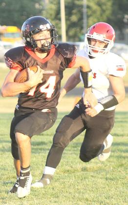 Pawnee City’s Jett Farwell (#14, left) takes off on one of his many ball-carrying duties in the game against Franklin on Thursday night. Paula Jasa/Republican