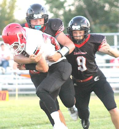 P.C.’s Joey Marteney hits a ball-carrier for a big stop in the backfield as teammate Jesse McLaughlin (#9, right) looks to help out. Paula Jasa/Republican