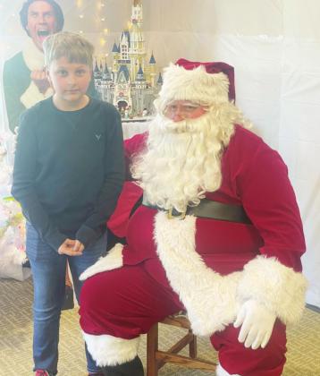Ray Kappel/Republican Derrick Porter visited Santa at the Pawnee City Public Library Saturday.