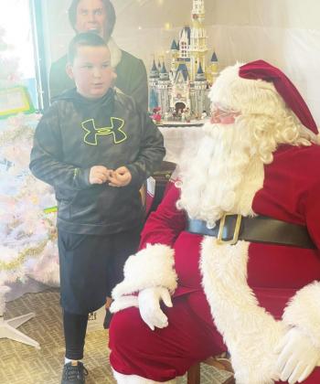 Ray Kappel/Republican Teagan Turnbull visited Santa at the Pawnee City Public Library Saturday. The kids were also treated to a movie.