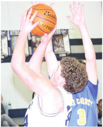 HTRS’ Andrew Stalder (#34, left) puts up a tough shot on the baseline against Tri-County. Paula Jasa/Republican