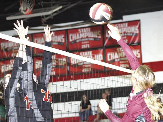 LHS’ Justice Currie (right) tries to slip a shot past Pawnee City’s Logan Maloley (#11, left) and Adelyn Sisco (#22) in last Tuesday night’s game. Paula Jasa/Republican