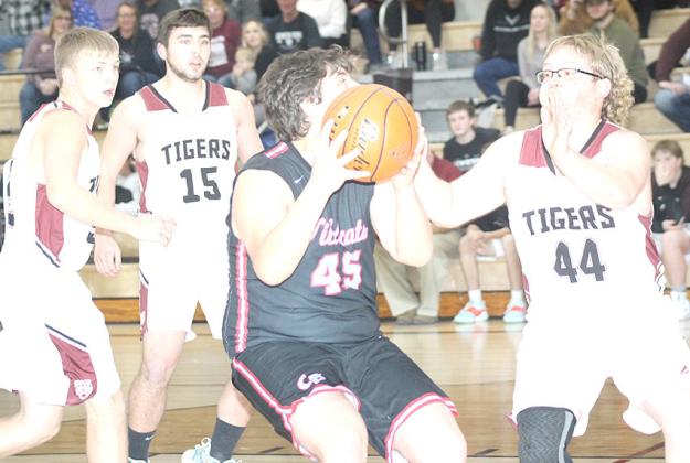 LHS’ Jaxon Janssen (#44, right) and teammates Brady Bledsaw (#15, left and Everett Bohling) defend the lane in Friday night’s game. Paula Jasa/Republican