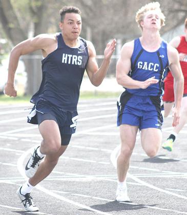 Paula Jasa/Republican HTRS’ JJ McQueen (left) rounds the corner in the 200 M. Dash. McQueen placed 5th in the finals.