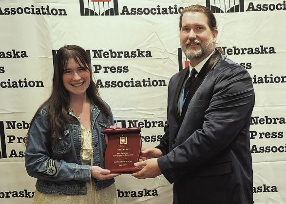 Reagan Connelly (left) receives the first place plaque from Timothy Linscott (right) on behalf of The Pawnee Republican Photo courtesy of Jeremy Buss