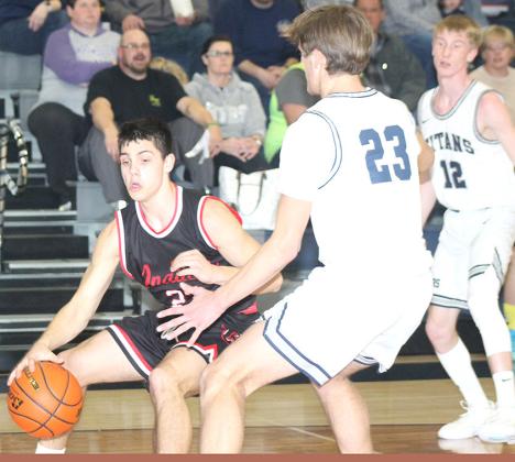 P.C.’s Anthony Kling (left) drives the baseline against HTRS’ Brandt Leech (#23, right) and also pictured is Brogan Dunlap (#12). Kling scored 27 points against HTRS. Paula Jasa/Republican