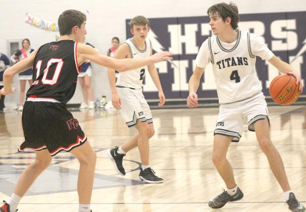 HTRS’ Jack Hunzeker (#4, right) brings the ball up against P.C.’s Drew Menninga (#10, left) in Tuesday night’s game as Brennen Vaughan (#2) watches. Paula Jasa/Republican