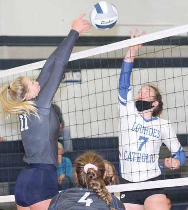 HTRS’ Katilyn Glathar (#11, left) gets her hands on a block as teammate Natalie Novak (#4) is on defense. Paula Jasa/Republican