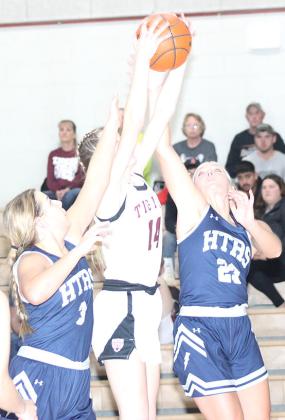Lewiston’s Meagan Sanders (#14, center) goes up against HTRS’ Laramie Glathar (#3, left) and Jaylie Mc-Nealy (#23, right) for a rebound. M. Sanders collected 12 rebounds in the game against HTRS last Tuesday. Jasa/Republican
