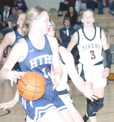 HTRS’ Jaylyn Bohling (#1, left) drives down the floor against Lewiston including Katelyn Sanders (#3, right). Paula Jasa/Republican