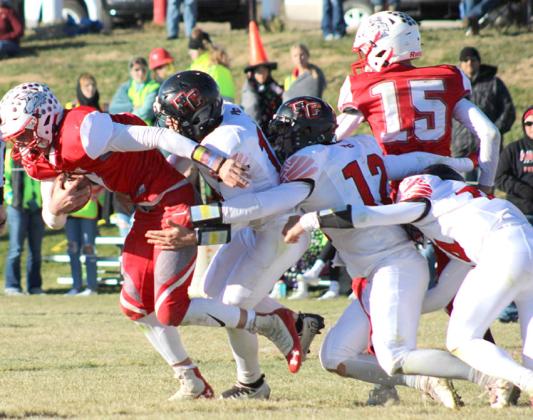 P.C.’s tackling squad of Anthony Kling, Andy Maloley and Jett Farwell pursue a Potter-Dix ball carrier in Friday’s quarterfinal game which P.C. won 62-47. photo courtesy of Jamie Maloley
