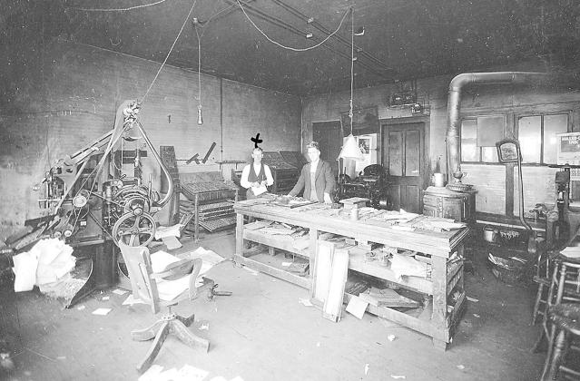 In the offices of the Table Rock Argus, circa 1921. Editor Frank Taylor is marked by an X, we don’t know the name of this assistant.