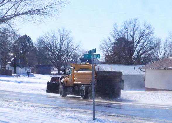 Snow plow heads down Highway 50.
