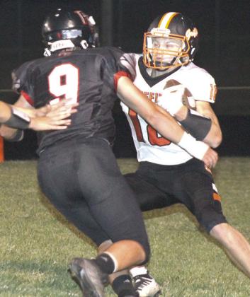Pawnee City’s Anthony Kling (pictured above, left) gets teammate Jett Farwell (#14, right) to block out in front for him during a run against Diller/Odell on Friday night. Pictured right is P.C.’s Jesse McLaughlin (#9) getting after a Griffin ball-carrier in the backfield. All three seniors played their last game at Pawnee City in their 75-7 victory. photos by Paula Jasa/Republican