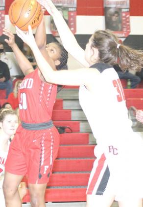 P.C.’s Tristen Bradbury (#30, above right) battles a Friend player for a loose rebound in Friday night’s game. The Lady Indians defeated Friend by a huge 48-8 count. Paula Jasa/Republican