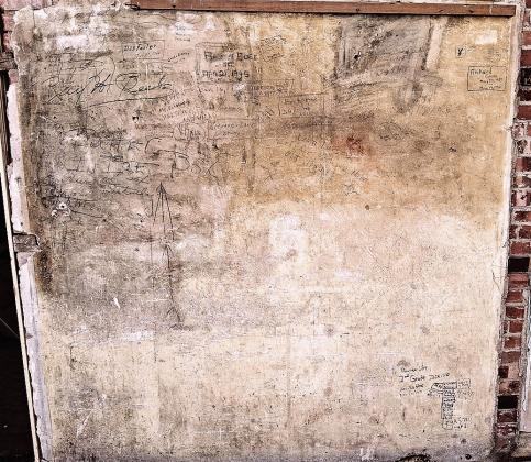 A full view of the back wall of Old Guys Brew where signatures dating back to the late ‘30s can be found