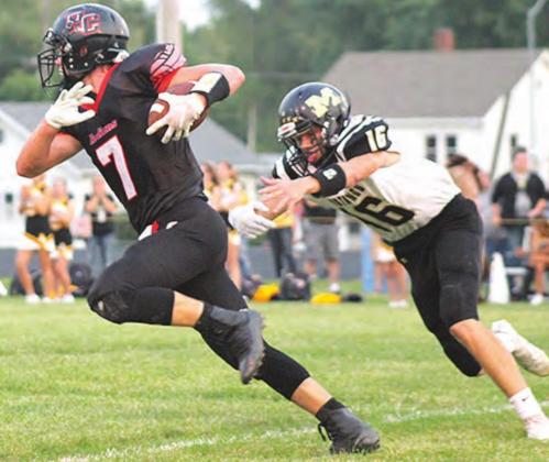 P.C.’s Kyle Gyhra (#7, left) avoids a tackle in the early part of the game against McCool Junction. Paula Jasa/Republican