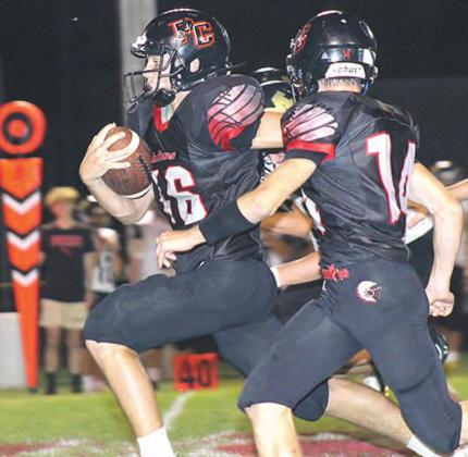 P.C.’s Anthony Kling (#16, front) has an escort in teammate Jett Farwell (#14, right) on a scamper towards the end zone late in the game. Paula Jasa/Republican