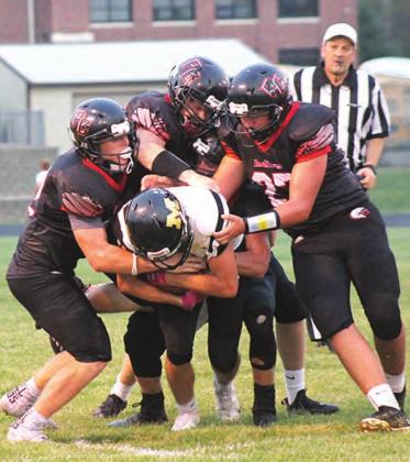 The Pawnee City Indian football team makes a gang tackle against the Class D-6 defending State Champions McCool Junction on Friday night. The Indians knocked off the defending State Champs by an overwhelming 72-44 score. Paula Jasa/Republican