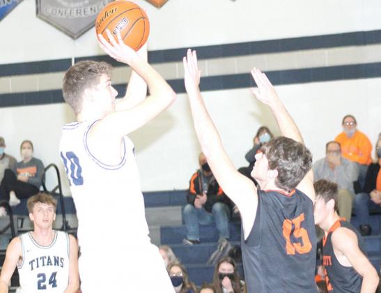 HTRS’ Trevor Plager (#10) goes up for a jumper against Falls City as teammate Jacob Joy (#24, left) looks on. Plager scored 8 points in the game. Paula Jasa/Republican